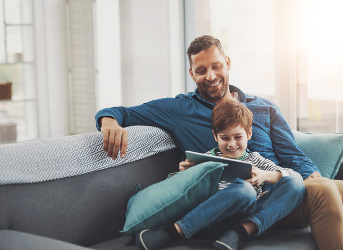 Father and son with device - Is Commercial Electricity Cheaper Than Residential