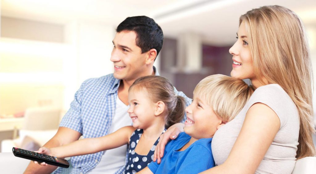 Family watches TV - 10 Ways To Save Electricity At Home