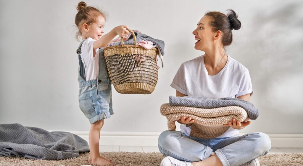 Woman doing laundry - 10 Ways To Save Electricity At Home