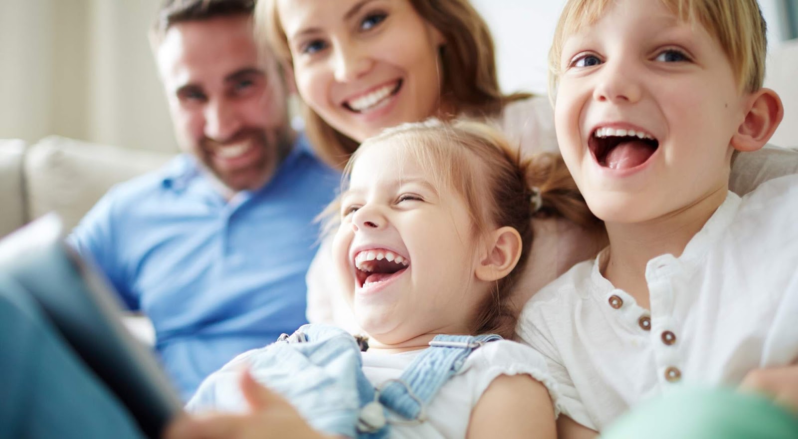 Family laughing, small children. Power Wizard can help your family find Abilene Electricity plans.