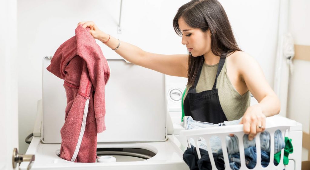 Woman doing laundry. Are Electric Rates Higher In Summer Or Winter?