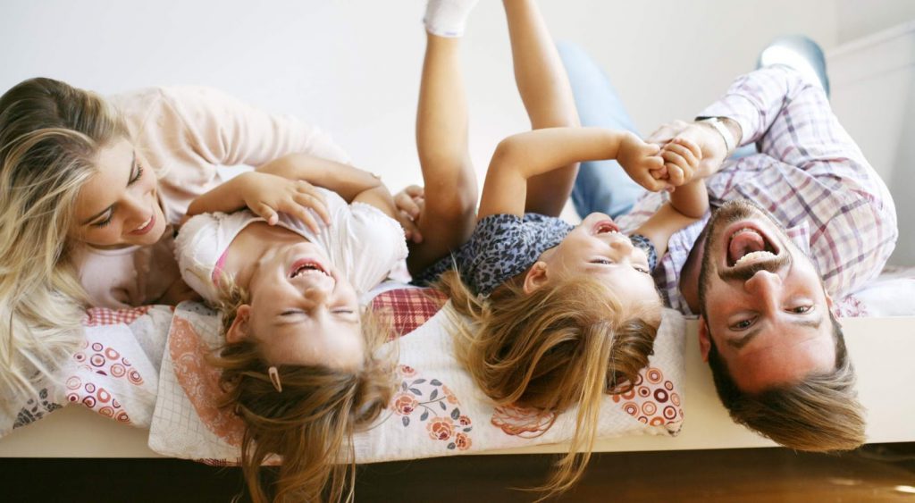 Happy family on bed. Constellation NewEnergy