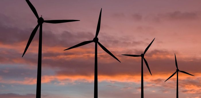 Windmills at sunset. Cost Per Kwh By Source