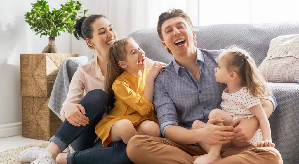 Happy family in living room. Dallas Electricity