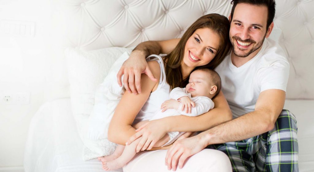 Happy family on bed. Electric Companies In Central Texas