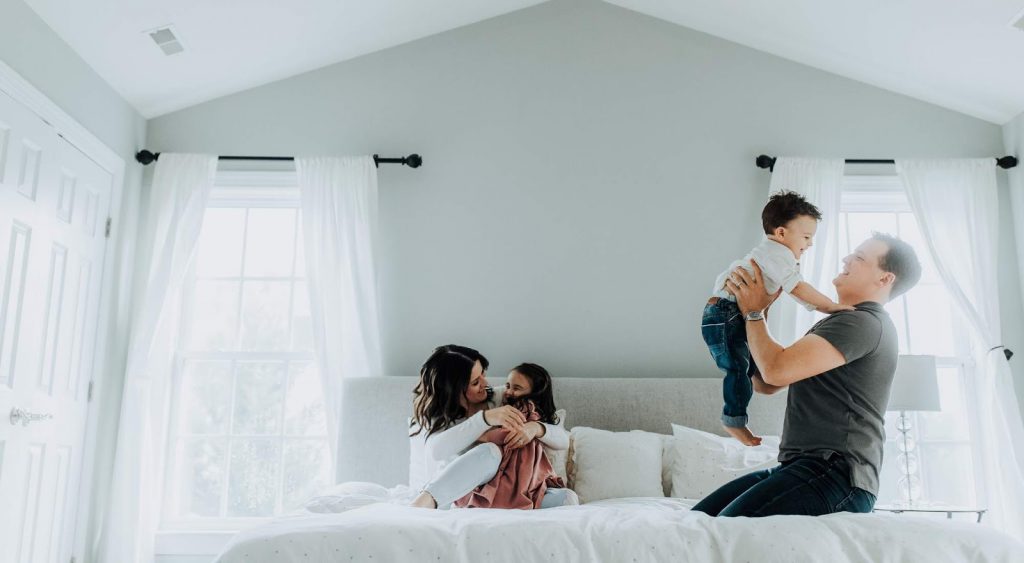 Happy family on bed - Electric Rates By Zip Code
