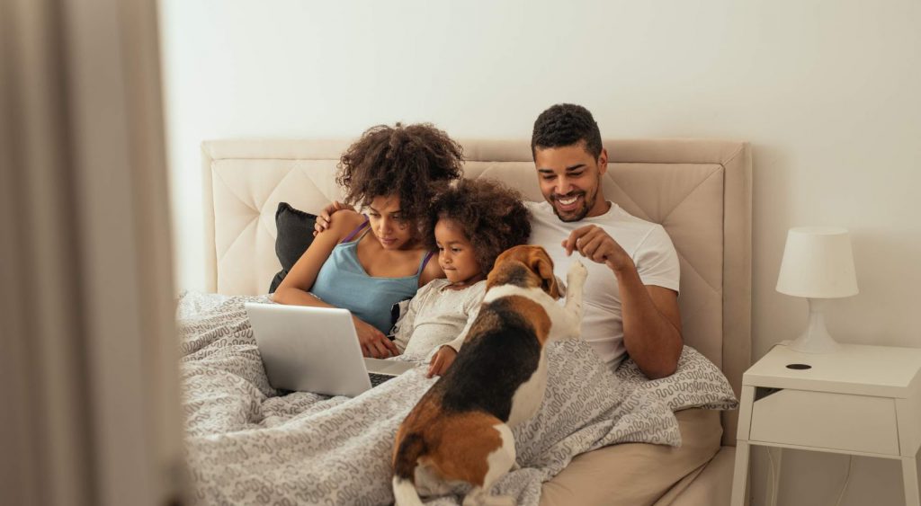 Happy family in bed - Electricity Companies Fort Worth