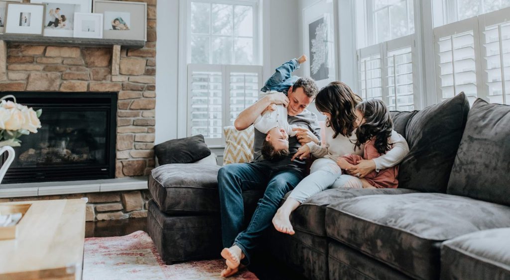 Happy family on couch - Electricity Plans