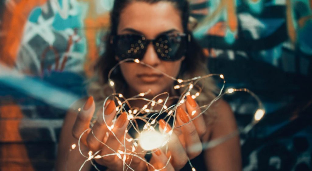 Woman with string lights - Energy Companies