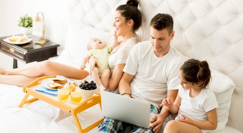 Happy family in bed - Galveston Electricity