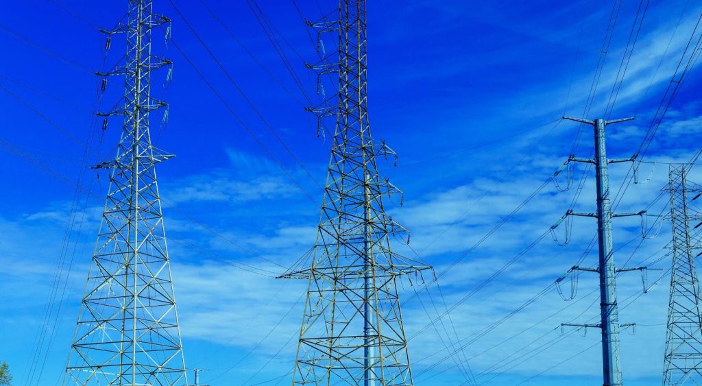 Power lines against sky. Griddy Energy