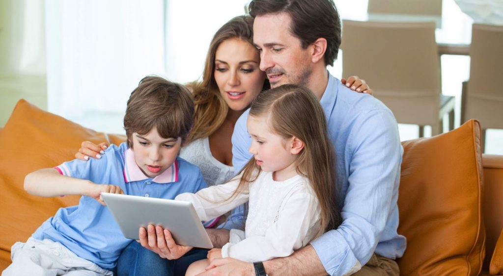 Happy couple with children read book - In Contract