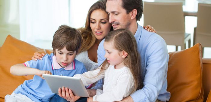 Happy couple with children read book - In Contract