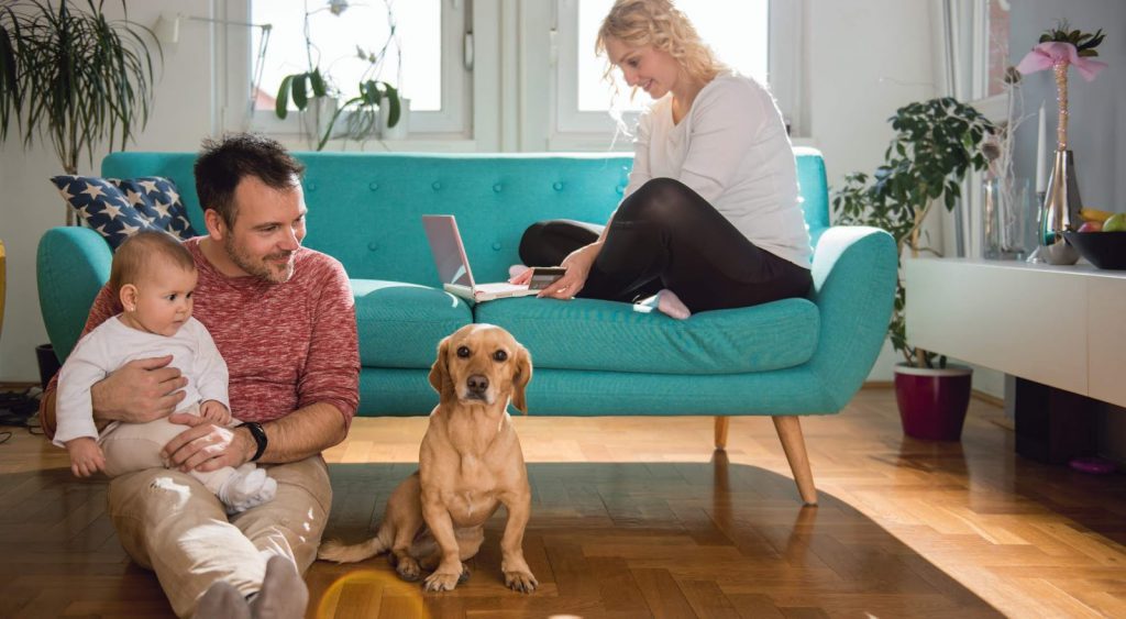 Happy family with dog indoors. Infuse Energy.