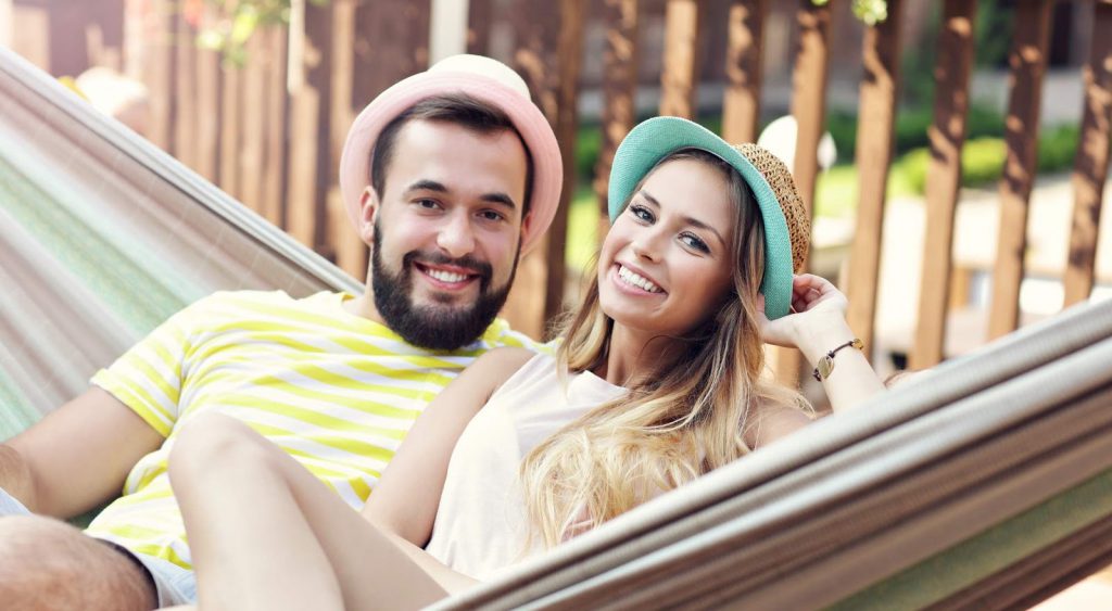 Smiling couple on hammock. Inspire Energy
