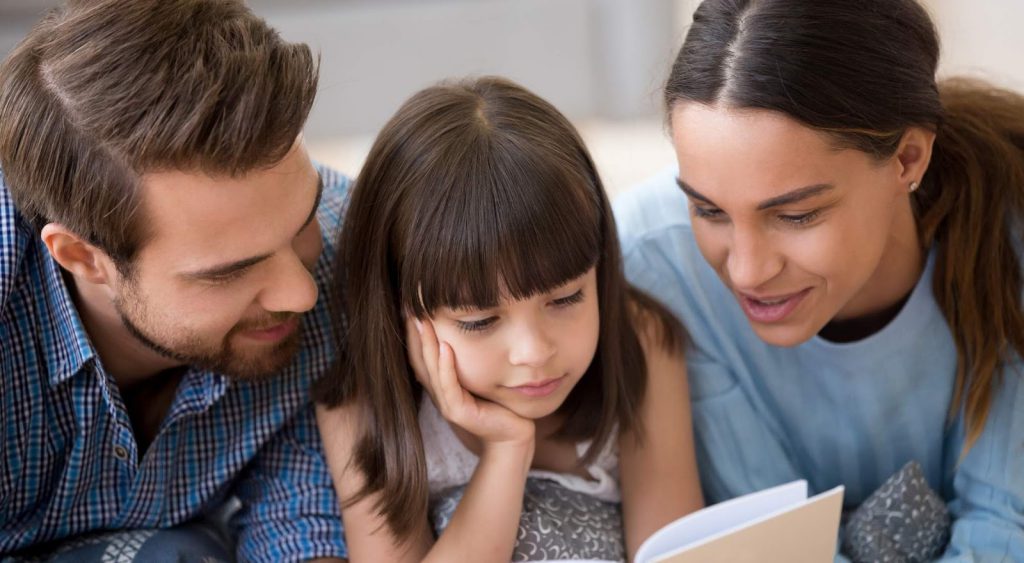 Happy family reading - Is Commercial Electricity Cheaper Than Residential