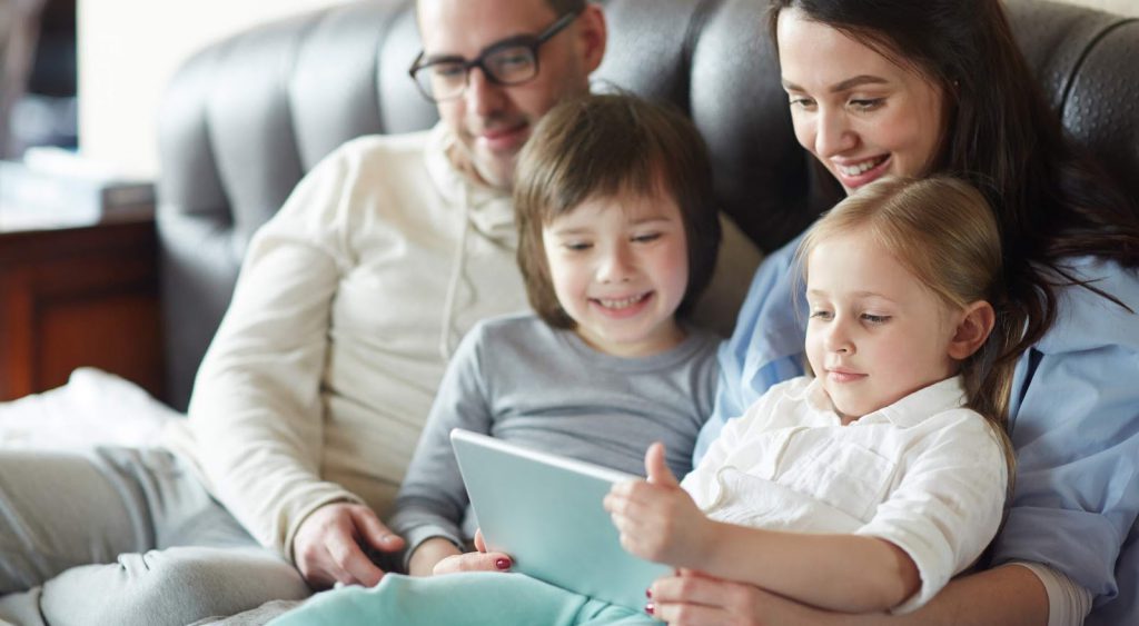 Happy family using device - KwH Calculator