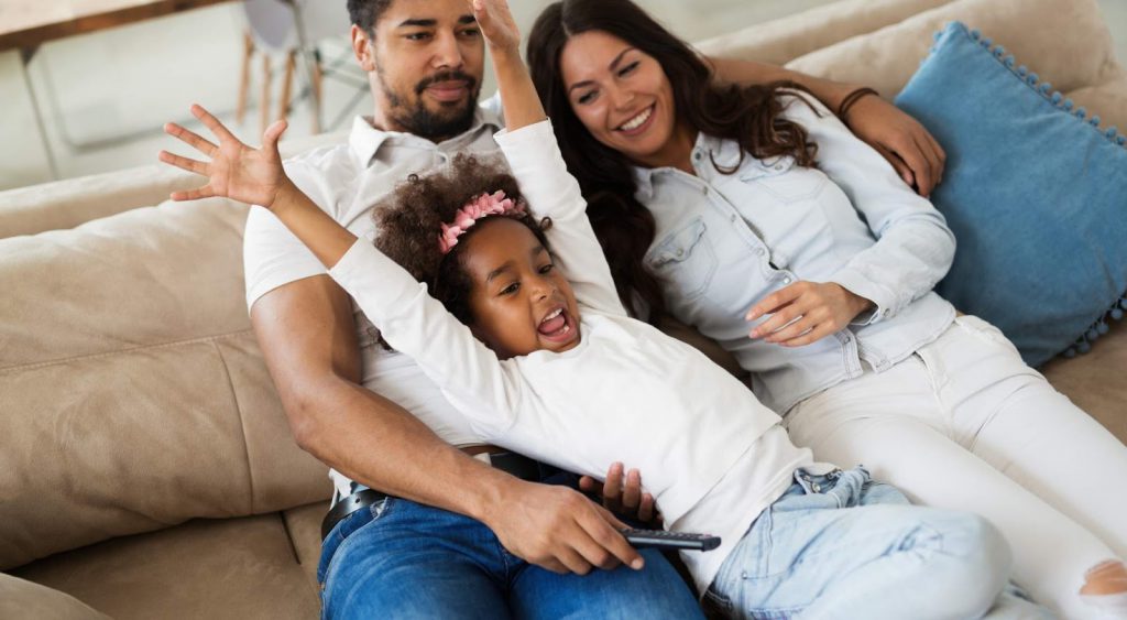 Happy family watching TV - Laredo