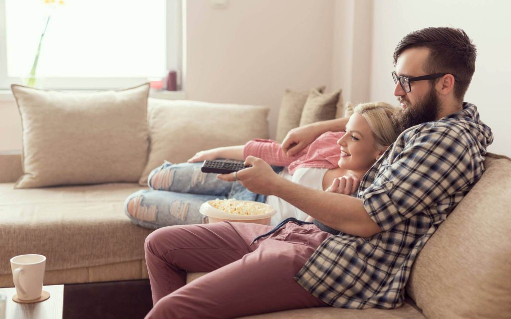 Couple watching TV - Light Companies