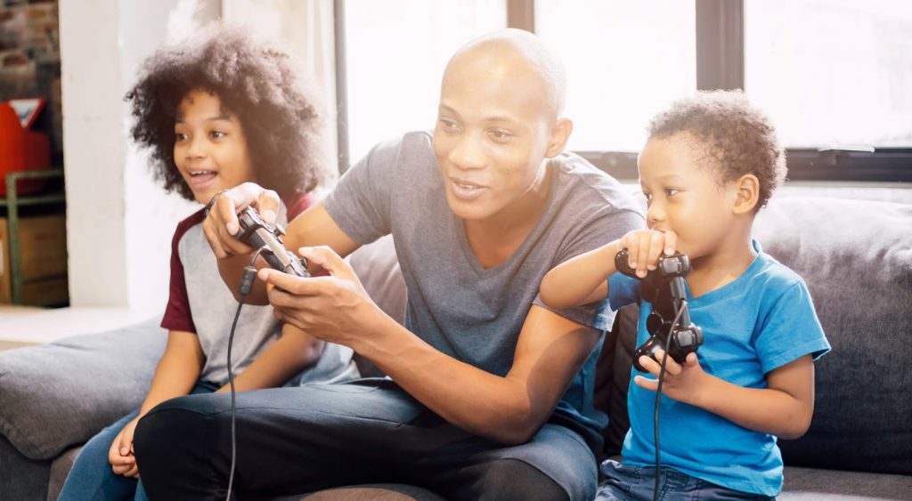 Father and sons playing video games - New Electric Companies In Texas