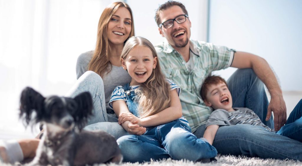 Happy family with dog on carpet - Odessa
