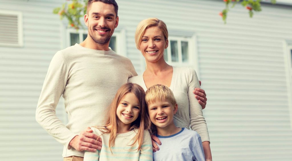 Happy family in front of house - Pogo Energy