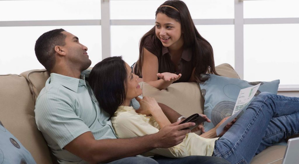 Happy family on couch - Tomorrow Energy