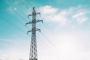 blue sky with electricity pole and power lines across