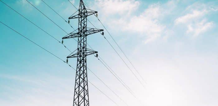 blue sky with electricity pole and power lines across