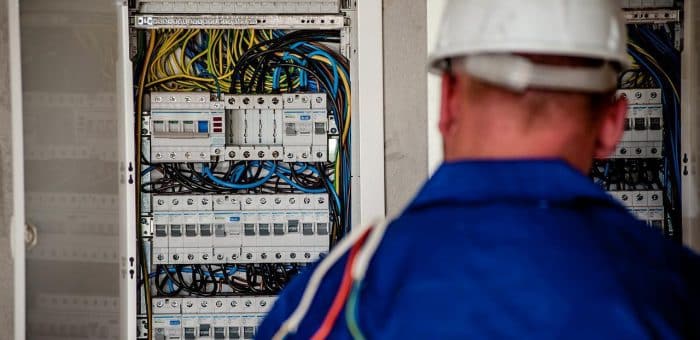 man in hard hat standing in front of breaker box
