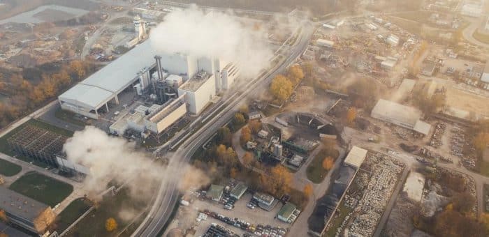 a city from above with smog coming from factories