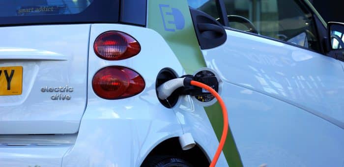 An electric vehicle plugged into an electric vehicle charger