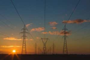 sun setting with electricity poles