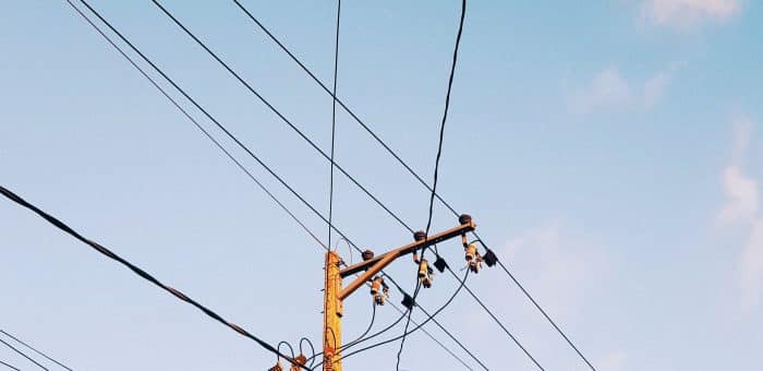a blue sky with a power line and pole