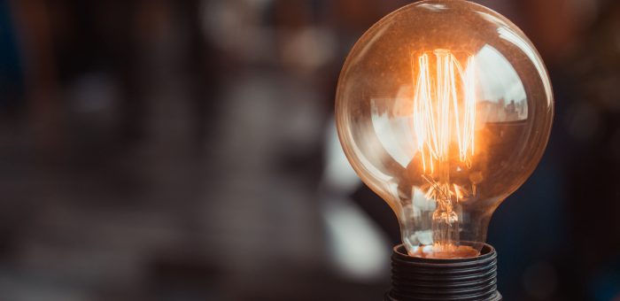 light bulb lit up in a dark room