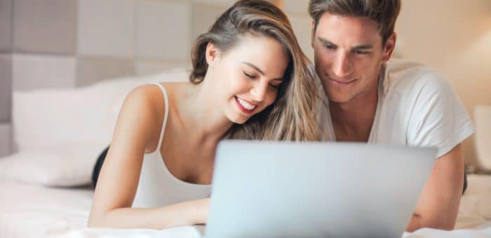 Couple reading their electricity bill via laptop